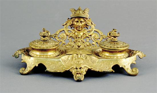 Appraisal: Continental brass inkwell late th centurycresting foliate backplate of mask