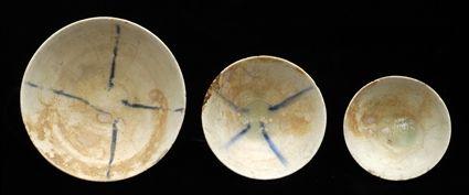 Appraisal: THREE ISLAMIC BOWLS White-glazed footed ceramic bowls of shallow conical