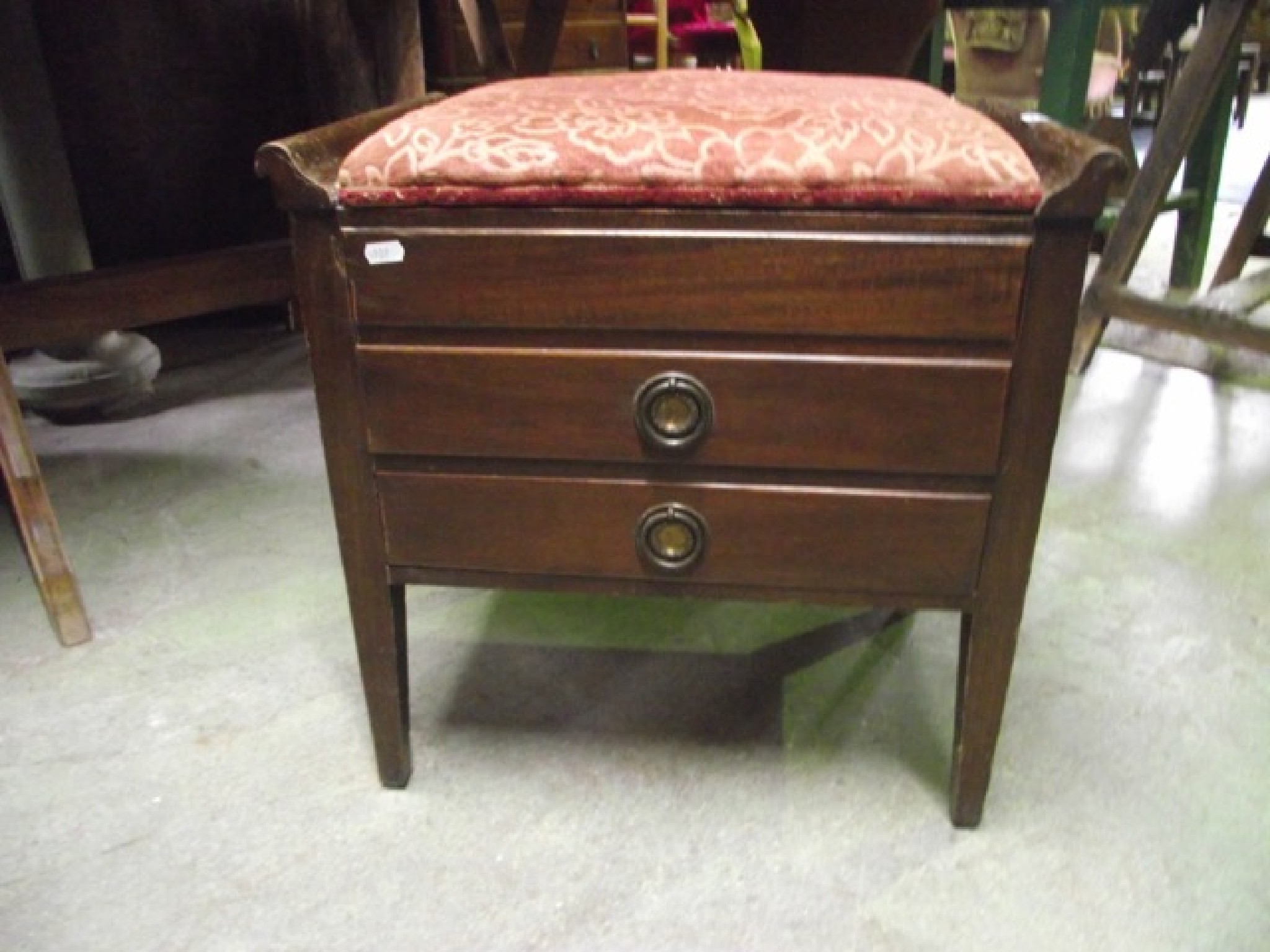 Appraisal: An Edwardian walnut piano stool with shallow upholstered box seat