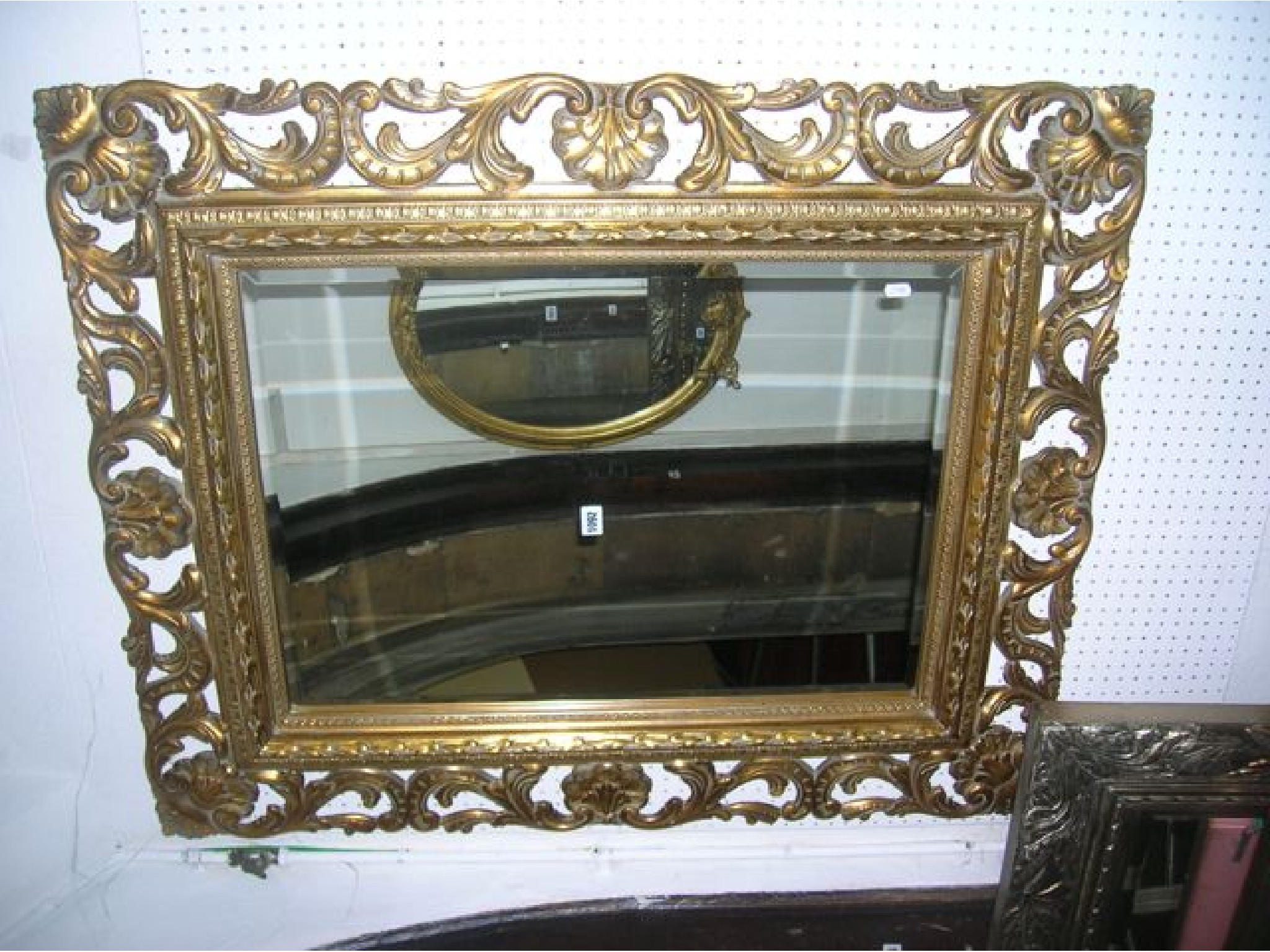 Appraisal: A contemporary reproduction wall mirror of rectangular form the bevelled