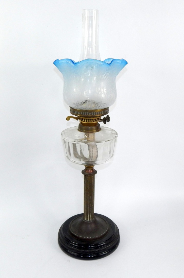 Appraisal: A Duplex brass oil lamp raised on a black glass