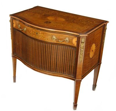 Appraisal: A harewood and marquetry serpentine front commode with gilt metal