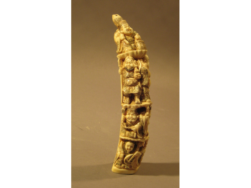 Appraisal: CARVED IVORY FIGURE GROUP The front carved vertically with seven