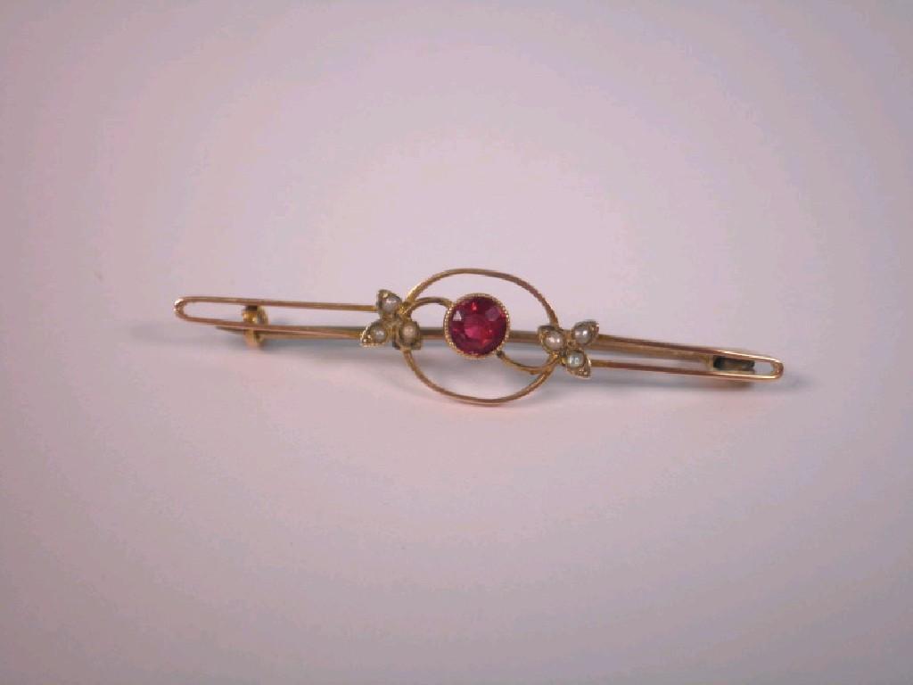 Appraisal: A bar brooch set with central red stone and seed