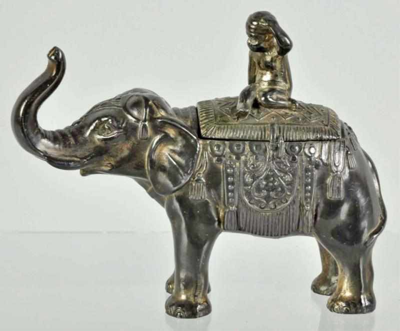 Appraisal: Pot Metal Boy Riding Elephant Still Bank Description Mostly likely