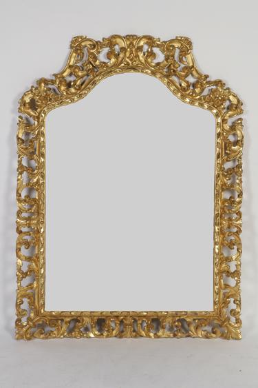 Appraisal: A BAROQUE STYLE GILT WOOD WALL MIRROR the arch topped