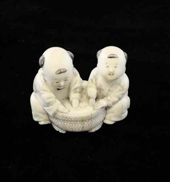 Appraisal: A Japanese ivory netsuke early th century carved as two