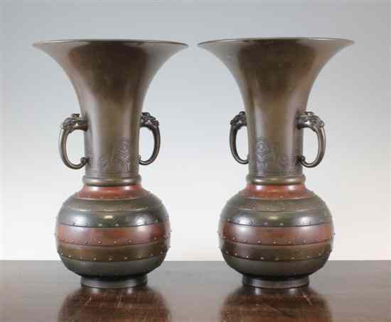 Appraisal: A pair of Japanese three colour patinated bronze twin handled