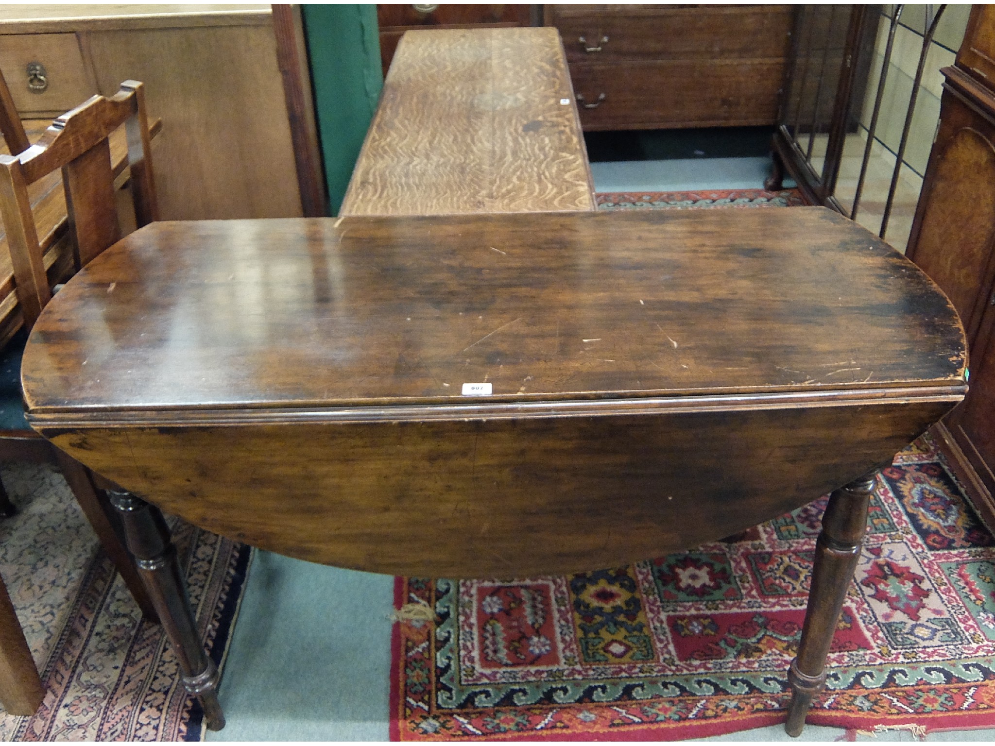 Appraisal: Oak drop leaf dining table with a Victorian Pembroke style