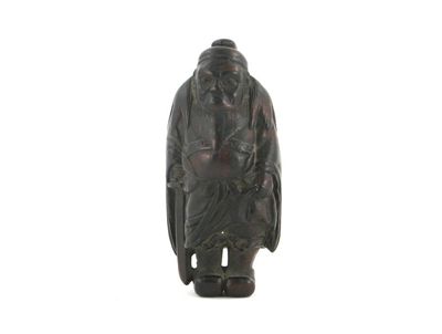 Appraisal: A good Japanese wood netsuke of Shoki standing in a