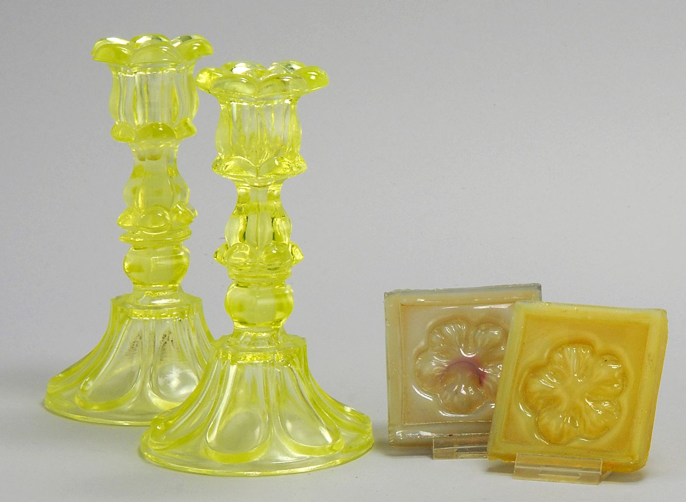 Appraisal: TWO GLASS CANDLESTICKS AND TWO GLASS TILES Pair of Sandwich