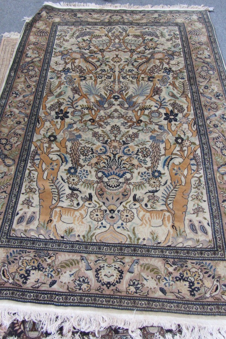 Appraisal: An Indian rug the ivory field with a forest scene