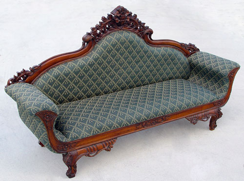 Appraisal: HEAVILY CARVED MAHOGANY VICTORIAN STYLE SOFA th C modern manufacture