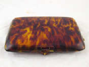 Appraisal: A moulded tortoiseshell minaudiere vanity case with mirror comb and