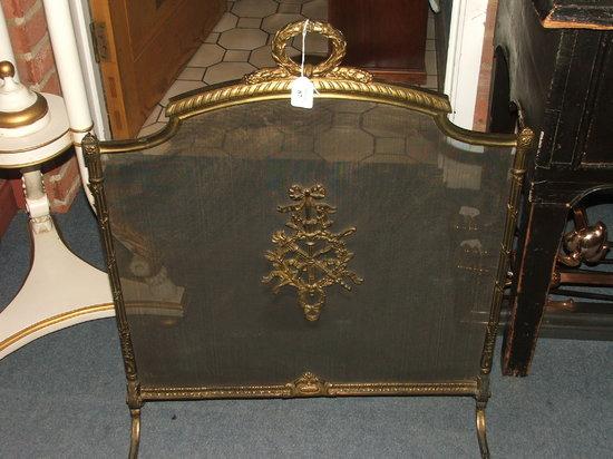 Appraisal: A FRENCH BRASS AND WIRE MESH FIRE GUARD with laurel