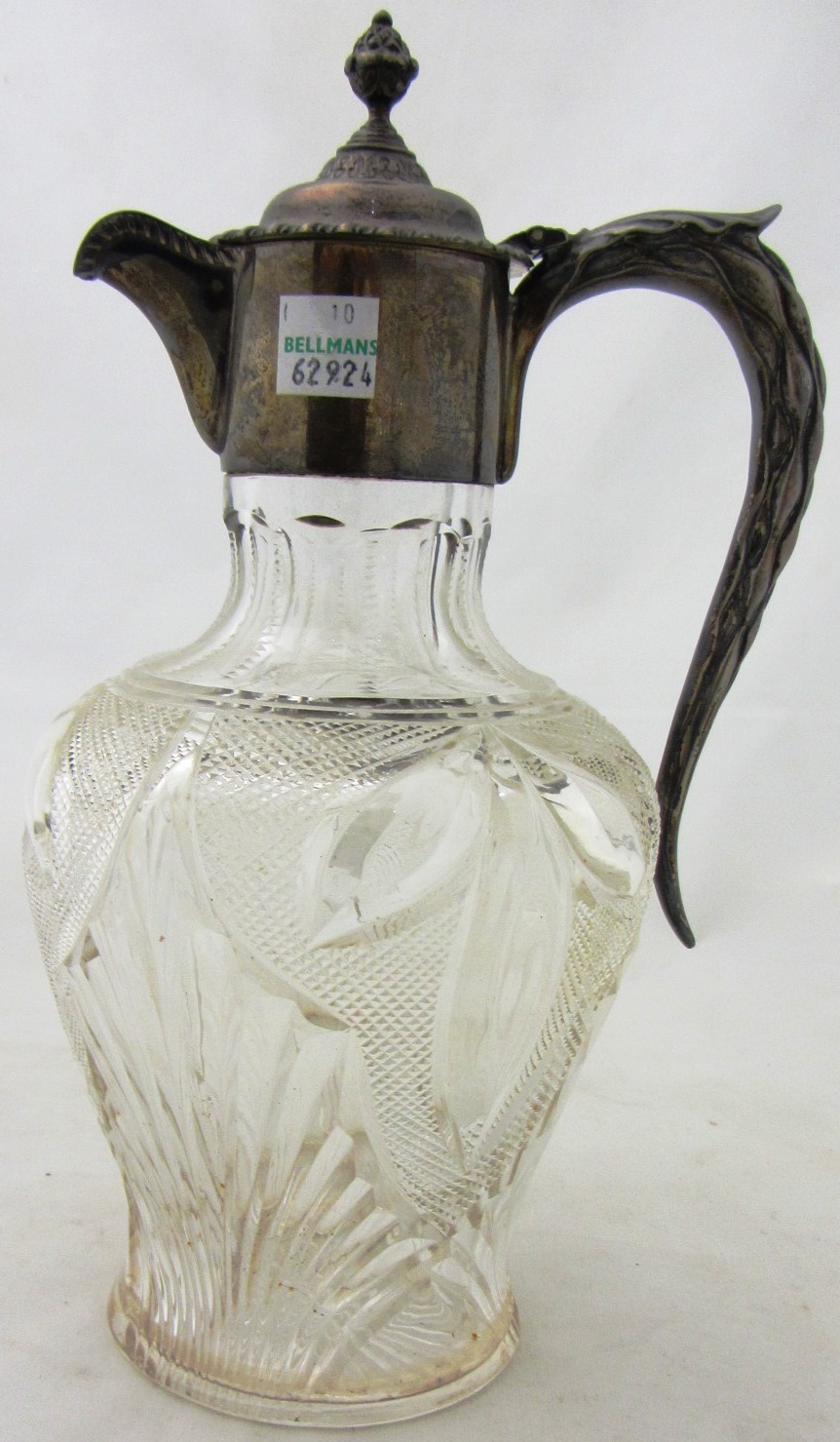 Appraisal: A Victorian silver mounted faceted glass claret jug decorated with