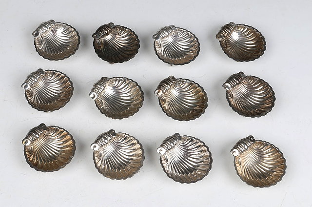 Appraisal: A SET OF TWELVE SILVER SCALLOP SHELL BUTTER DISHES stamped