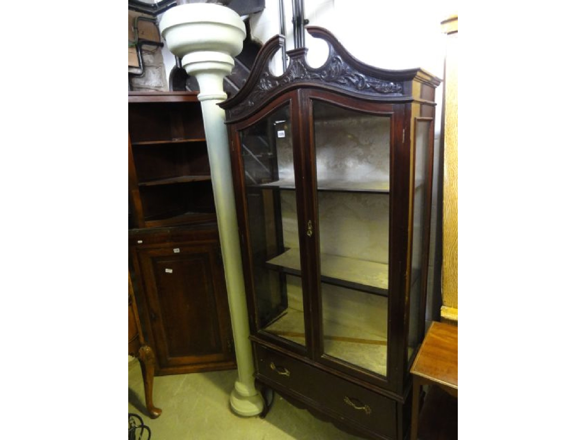 Appraisal: An Edwardian mahogany freestanding display cabinet with broken architectural swan