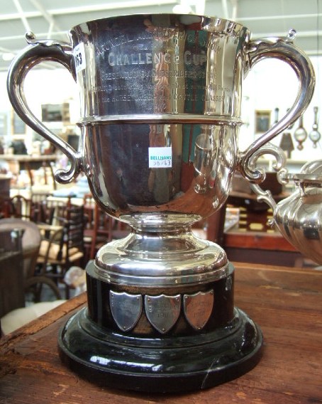 Appraisal: A silver twin handled trophy cup presentation inscribed Sheffield on