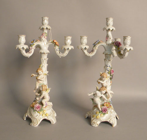 Appraisal: Pair of German porcelain candelabra with cupid and floral decoration