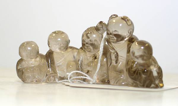 Appraisal: A rock crystal brush rest Delightfully fashioned as five boys