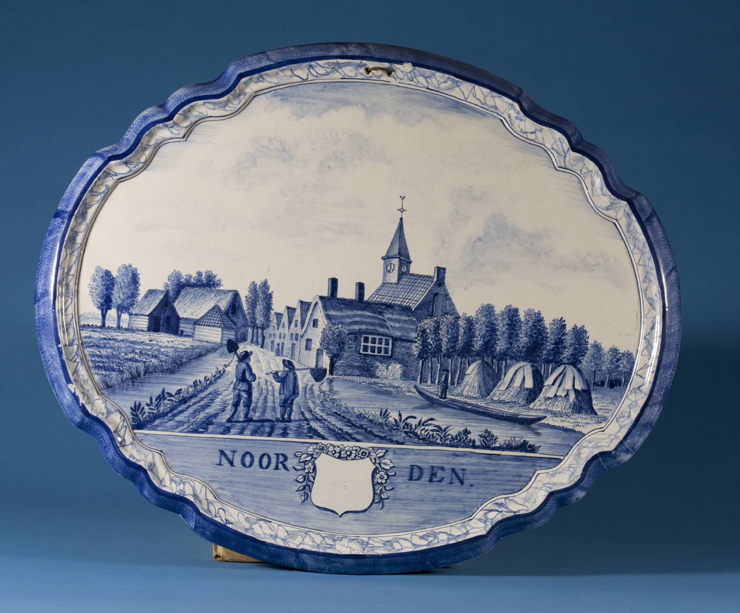 Appraisal: MAKKUM FRISIAN FAIENCE BLUE AND WHITE SHAPED OVAL PLAQUE DEPICTING