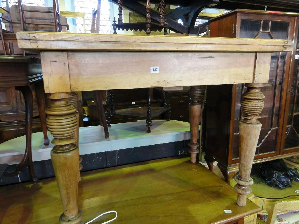 Appraisal: A stripped and waxed pine fold over top kitchen table