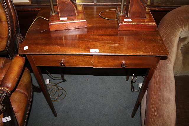 Appraisal: A MAHOGANY SIDE TABLE fitted two drawers on tapering supports