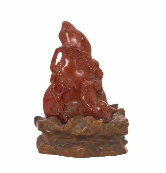 Appraisal: A Chinese Amber Carving depicting a seated figure under a