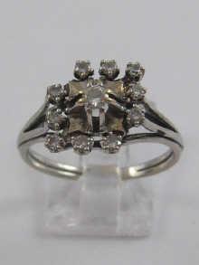 Appraisal: A white metal tests carat gold diamond cluster ring