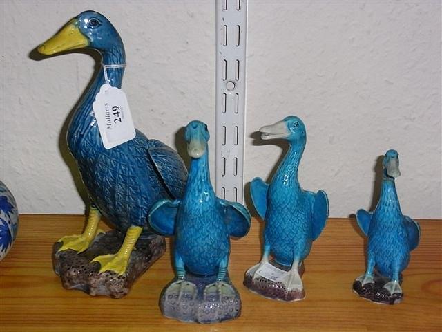 Appraisal: FOUR MODERN CHINESE GRADUATED POTTERY DUCKS one with faults