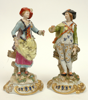 Appraisal: A PAIR OF CONTINENTAL PORCELAIN FIGURES HOLDING FLOWERS