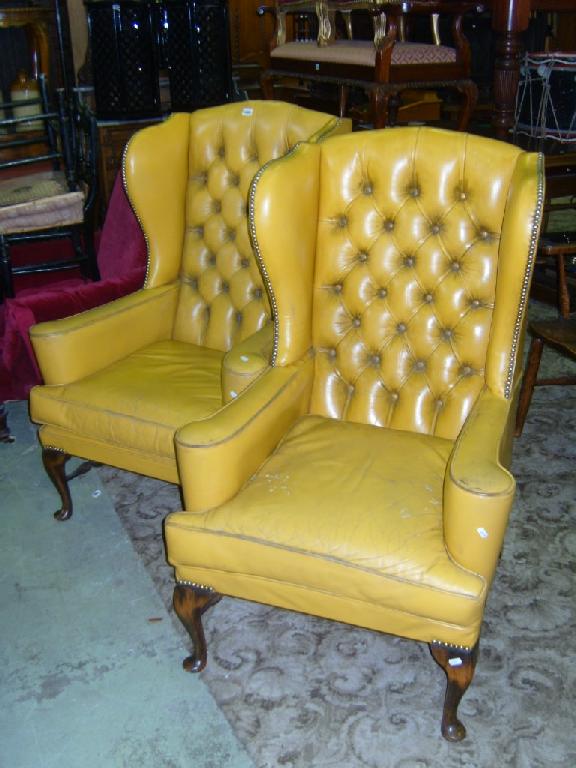 Appraisal: A pair of Georgian style wing easy chairs with button