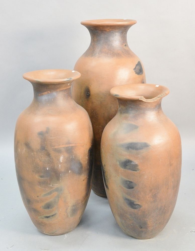 Appraisal: Three outdoor terracotta urns one with chipped rim ht Estate