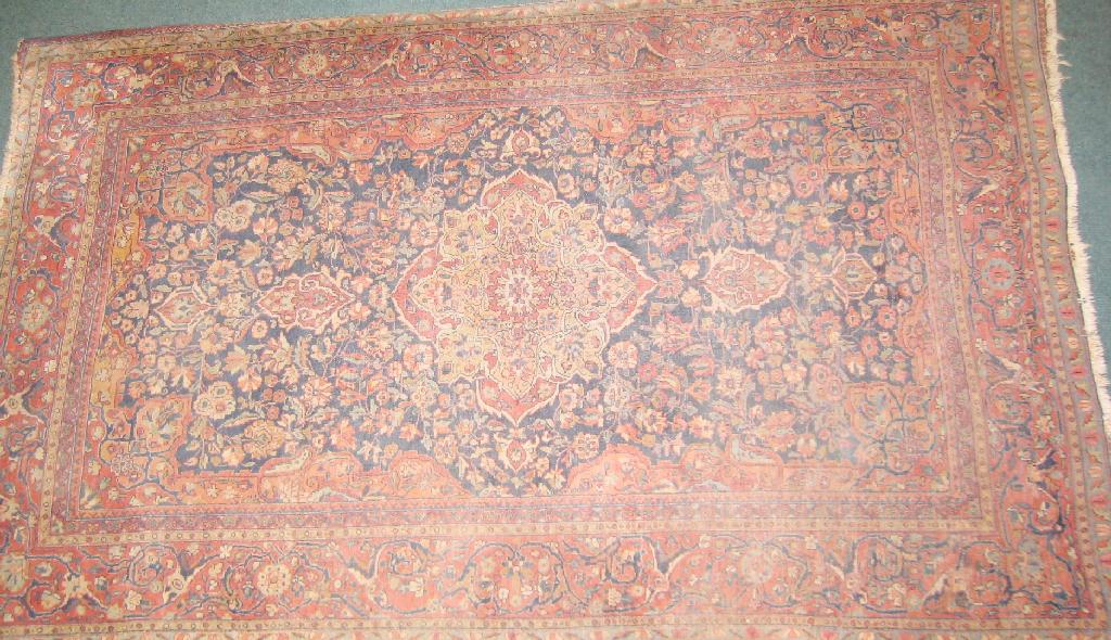 Appraisal: A bordered Kashan Rug with floral medallion and corner design