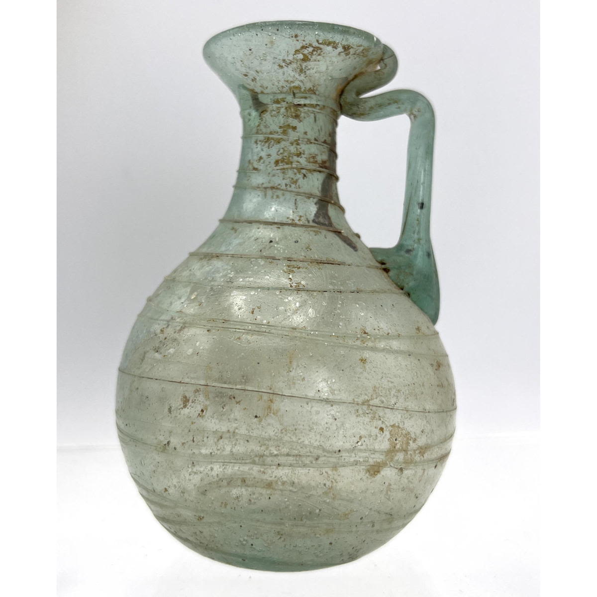 Appraisal: Spiral thread handled jug Ancient Roman glass Green Dimensions H