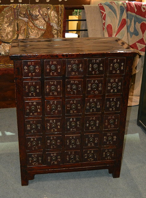 Appraisal: A Chinese stained elm medicine cupboardwith numerous drawers having inlaid