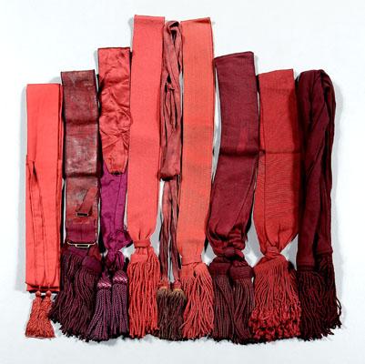 Appraisal: Nine military sashes with tassels fabrics in shades of purple