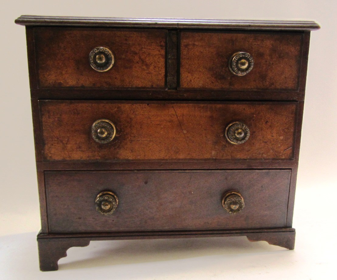 Appraisal: A th century miniature mahogany chest of two short and