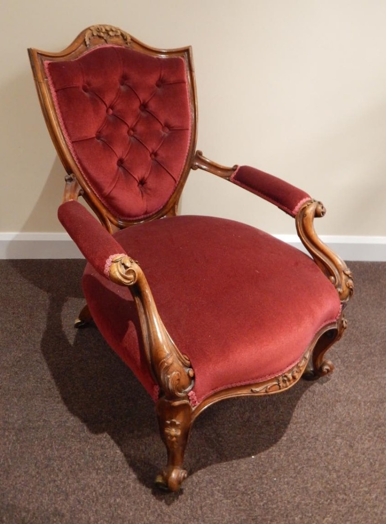 Appraisal: A Victorian rosewood open armchair the shield shaped back carved