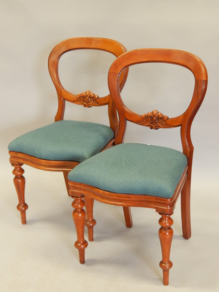 Appraisal: A pair of Victorian balloon back dining chairs each with