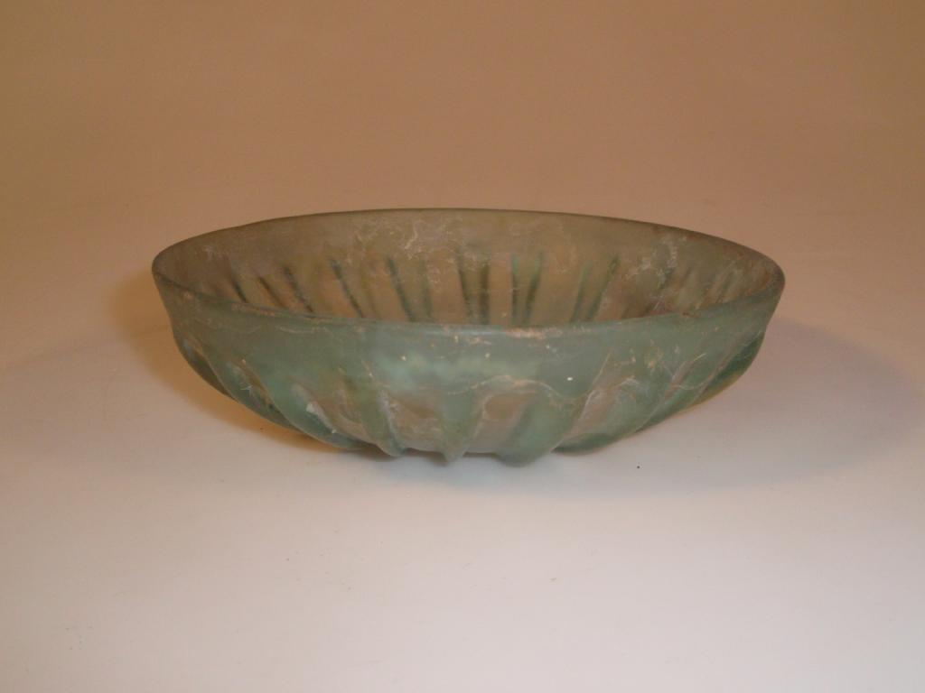 Appraisal: A bluish-green Roman 'pillar-moulded' cast shallow ribbed glass bowl decorated