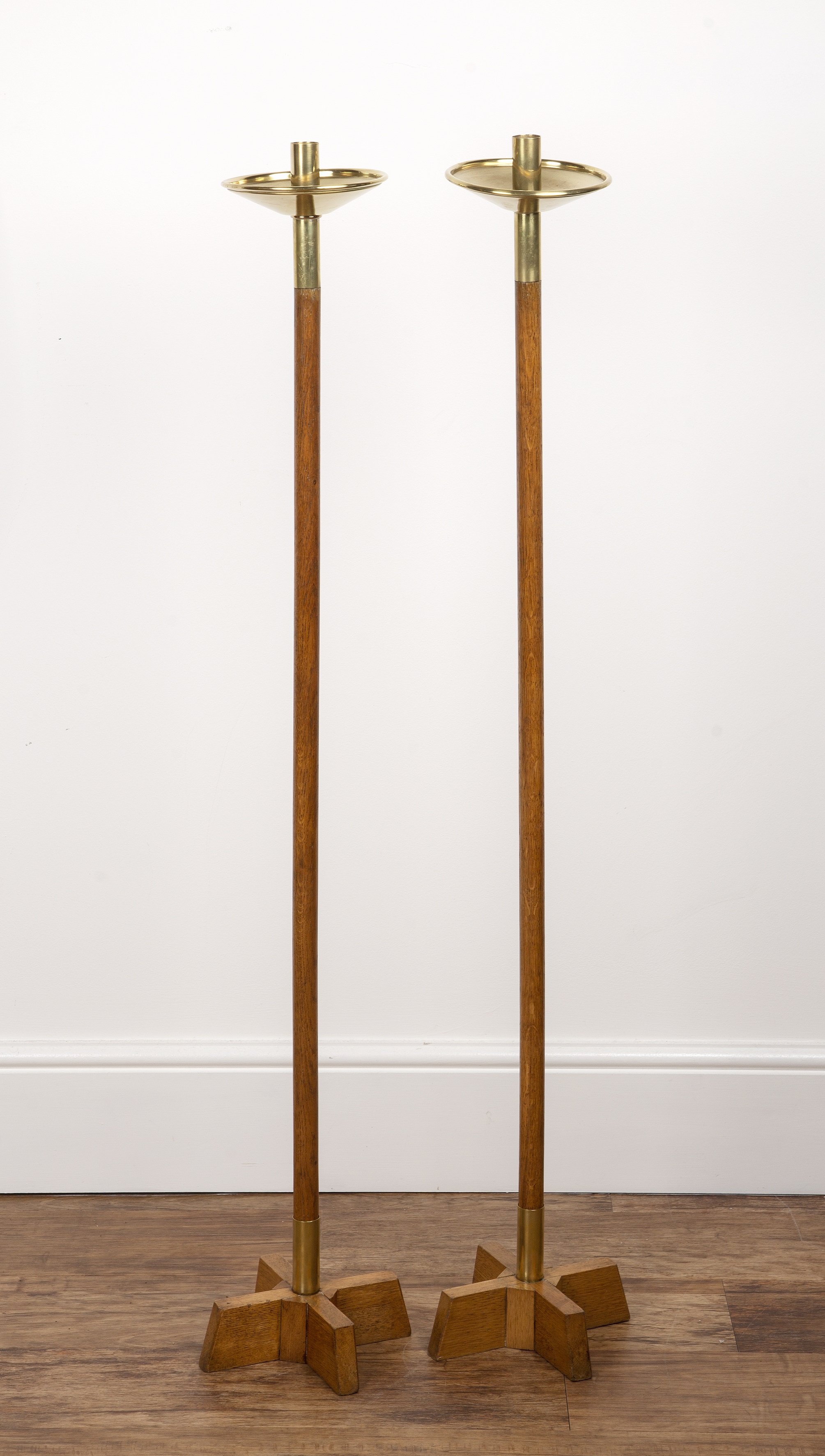 Appraisal: A pair of oak and brass tall floor standing candle