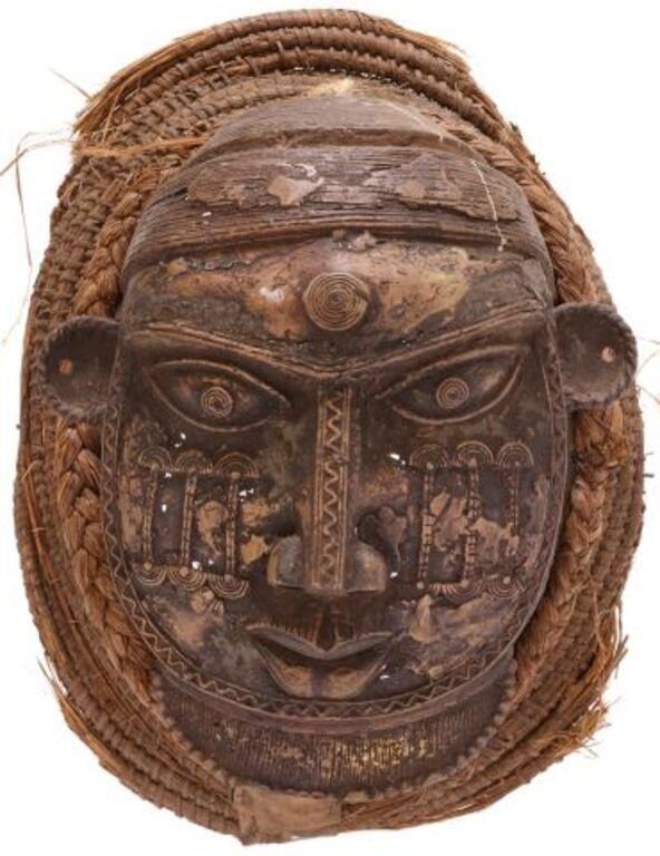 Appraisal: African patinated metal mask round face ornamented with concentric circles