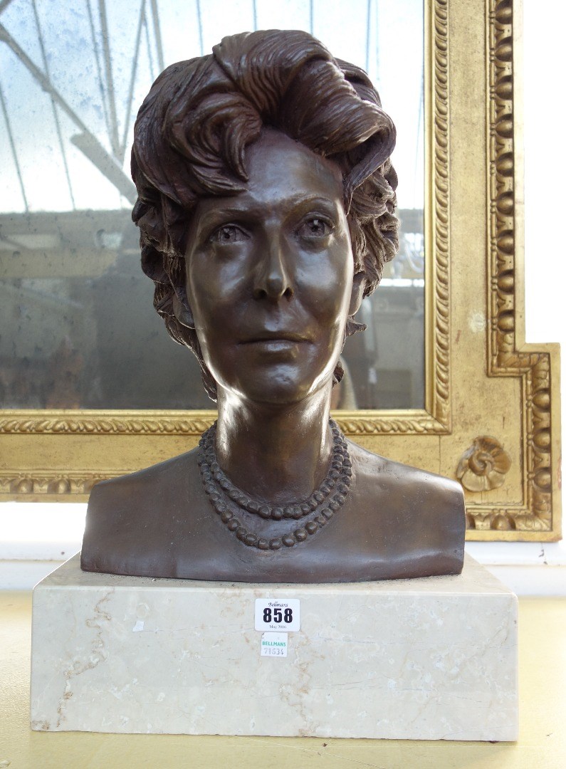 Appraisal: A bronze portrait bust depicting a female subject signed and