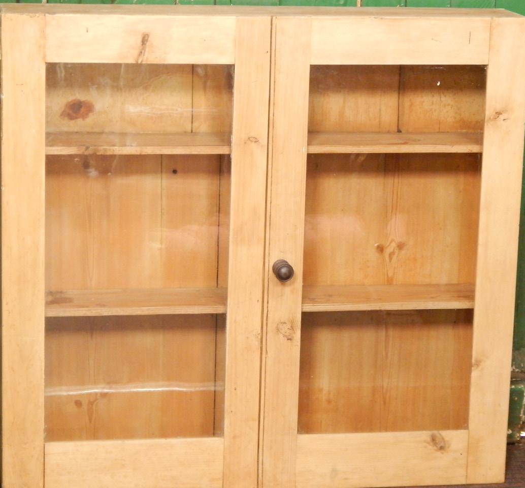 Appraisal: A Victorian shallow pine cabinet fitted with two shelves enclosed