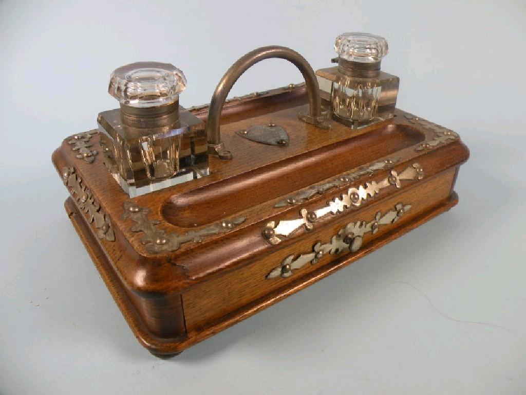 Appraisal: A Victorian oak rectangular ink stand with silver plated mounts