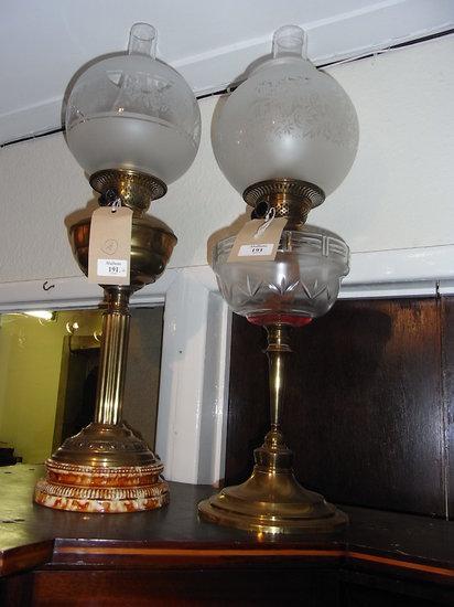 Appraisal: TWO OIL LAMPS each with etched glass globe shades one