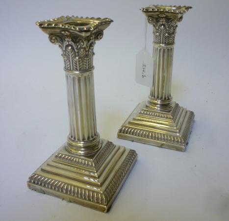 Appraisal: A PAIR OF CORINTHIAN COLUMN CANDLESTICKS maker's mark H E