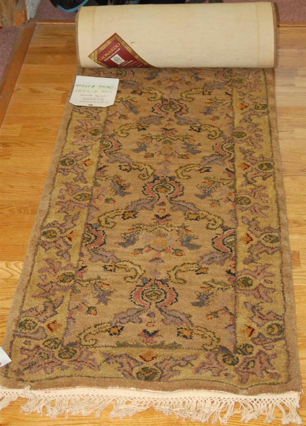 Appraisal: LOOMED WOOL RUNNER consisting of a tan ground oriental design